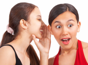Girl Telling A Secret To Her Friend